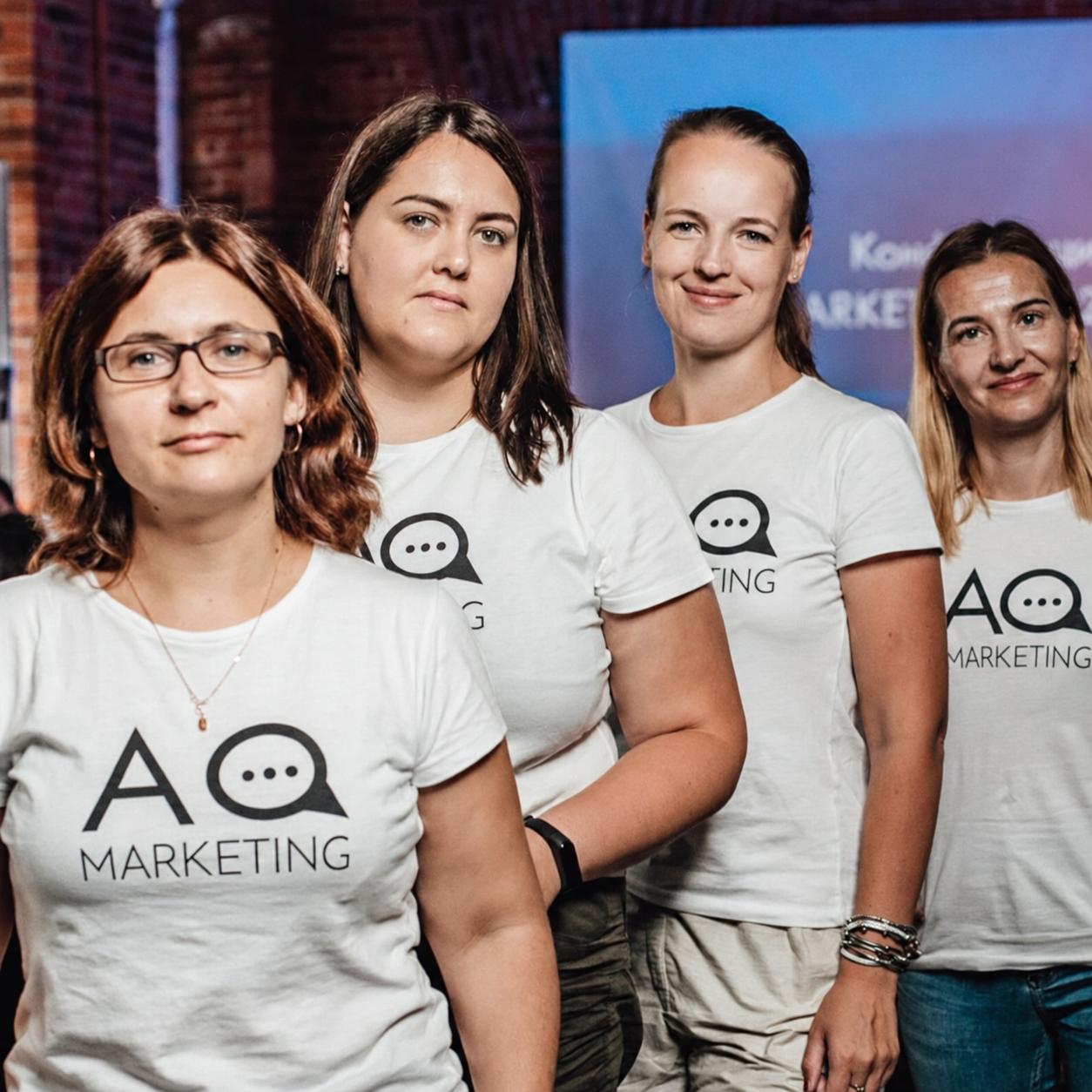 AQ Marketing specialists in branded shirts at a company event